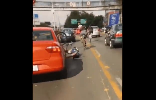 Ciclista libra la muerte tras caer al lado de un auto.