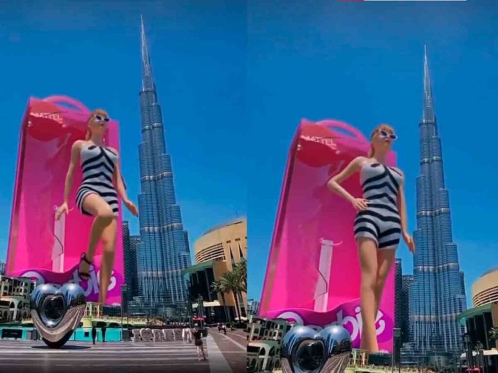 La enorme Barbie se muestra abriendo la tapa de plástico de su caja, saliendo de ella y posando ante el Burj Khalifa de Dubái.
